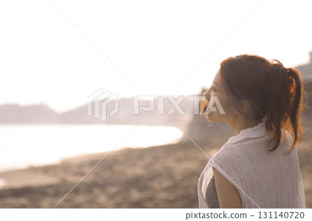 Shonan Coast - A woman on the beach at dusk 131140720