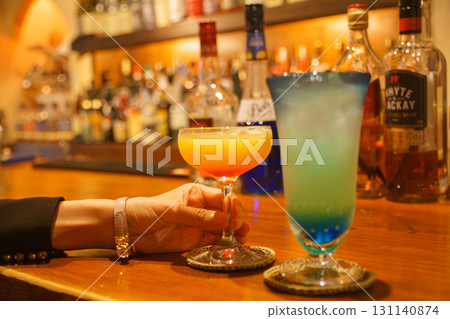 Woman's hands tasting a drink at an authentic bar Woman's hands tasting a drink at an authentic bar 131140874