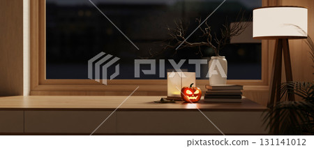 Glowing jack-o-lantern halloween pumpkin and high floor lamp on wooden table aside window a dim room Glowing jack-o-lantern halloween pumpkin and high floor lamp on wooden table aside window a dim room 131141012
