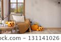 Wooden armchair aside table with carved jack-o-lantern halloween pumpkin and candles with spider web 131141026