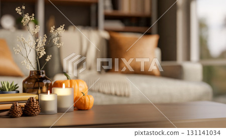 Orange pumpkin halloween props with candles on wooden table aside sofa and window in a living room. 131141034