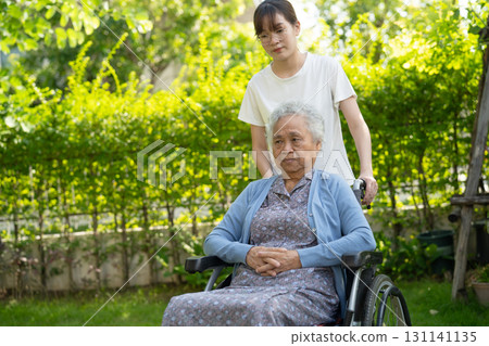 Caregiver help and care Asian senior woman patient sitting on wheelchair at nursing hospital ward, healthy strong medical. Caregiver help and care Asian senior woman patient sitting on wheelchair at nursing hospital ward, healthy strong medical. 131141135