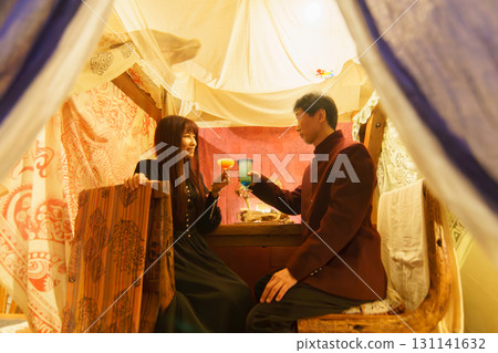 A couple toasting at an overseas resort. Moving abroad with FIRE 131141632