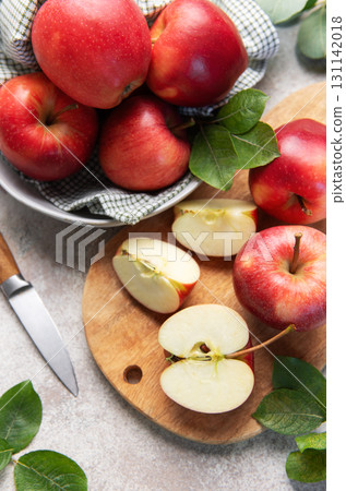 Red apples, whole and sliced, on cutting board Red apples, whole and sliced, on cutting board 131142018