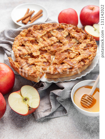 Apple pie with lattice crust, cinnamon sticks, fresh apples, honey 131142022