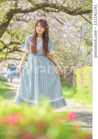 Portrait of a middle-aged woman with cherry blossoms in full bloom Portrait of a middle-aged woman with cherry blossoms in full bloom 131142191