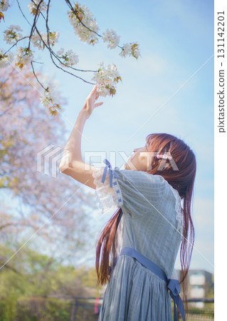 Portrait of a middle-aged woman with cherry blossoms in full bloom Portrait of a middle-aged woman with cherry blossoms in full bloom 131142201