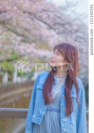 Portrait of a middle-aged woman with cherry blossoms in full bloom 131142291