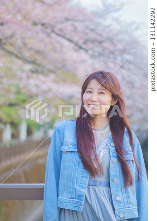 Portrait of a middle-aged woman with cherry blossoms in full bloom Portrait of a middle-aged woman with cherry blossoms in full bloom 131142292