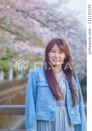 Portrait of a middle-aged woman with cherry blossoms in full bloom 131142293