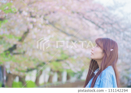 Portrait of a middle-aged woman with cherry blossoms in full bloom Portrait of a middle-aged woman with cherry blossoms in full bloom 131142294