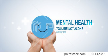 World Mental Health Day concept with hands holding happy smile face symbol, promoting support, awareness, positivity and emotional wellbeing, you are not alone. World Mental Health Day concept with hands holding happy smile face symbol, promoting support, awareness, positivity and emotional wellbeing, you are not alone. 131142343