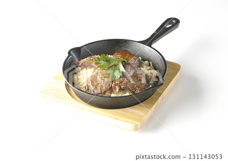 Garlic rice topped with grilled meat photographed on a white background Garlic rice topped with grilled meat photographed on a white background 131143053
