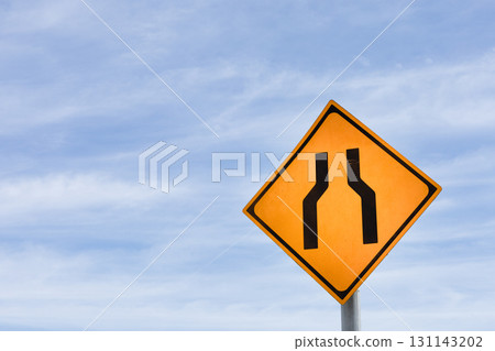 Sign indicating the road narrows ahead and copy space 131143202