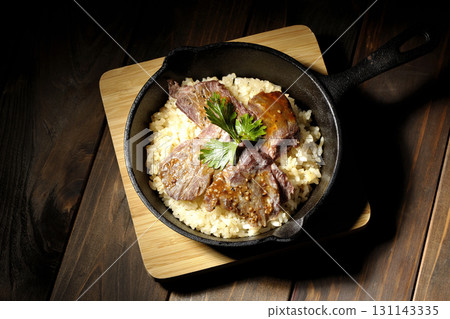 Garlic rice topped with grilled meat Garlic rice topped with grilled meat 131143335