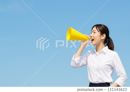 Young woman cheering with a megaphone (photo) 131143623