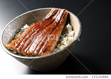 Eel bowl photographed alone against a black background Eel bowl photographed alone against a black background 131143666