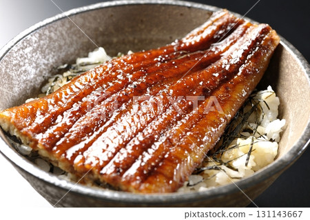 Eel bowl photographed alone against a black background Eel bowl photographed alone against a black background 131143667