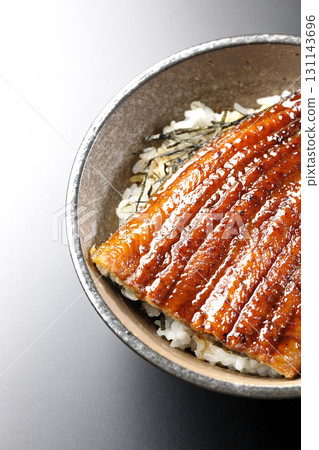 Eel bowl photographed alone against a black background Eel bowl photographed alone against a black background 131143696
