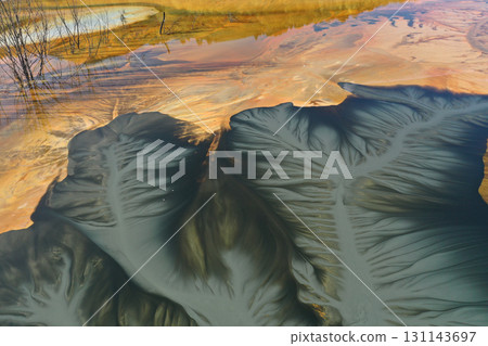 Flying over surreal patterns of flowing colorful mining chemical residuals aerial 131143697