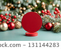 Round red podium on a festive background with Christmas decorations and soft bokeh lights 131144283