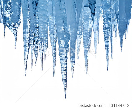 Sharp Icicles Hanging Against White Background in a Cold Winter Scene with Frozen Water Drops and Long Thin Sharp Icicles Hanging Against White Background in a Cold Winter Scene with Frozen Water Drops and Long Thin 131144730