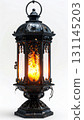 Ornate Iron Lantern with Glowing Amber Flame Against a White Backdrop 131145203