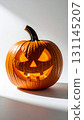 Carved Orange Halloween Pumpkin with Glowing Light on White Background 131145207