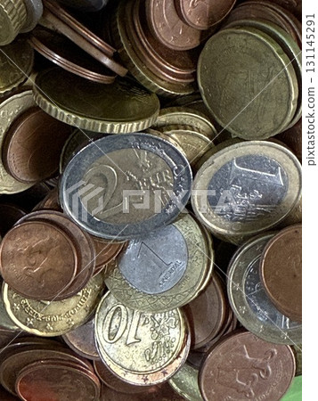Close-up of Euro coins in container. Glass piggy bank for money. Saving money to buy necessary things. 131145291