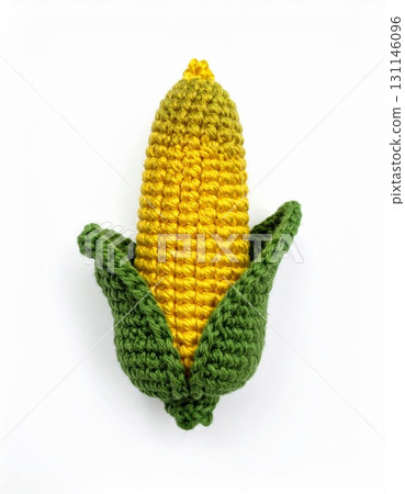 Handmade Crochet Corn Cob With Green Husks on White Background Knitted Yarns 131146096