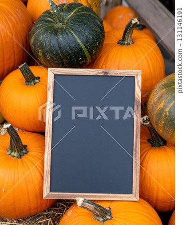 Assortment of Pumpkins and Gourd with Dark Blank Chalkboard in a Rustic Autumn Arrangement 131146191