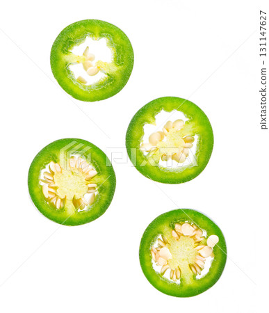 Fresh jalapeno pepper isolated on white background. Slices of green hot serrano pepper. Clipping path. Top view. Fresh jalapeno pepper isolated on white background. Slices of green hot serrano pepper. Clipping path. Top view. 131147627