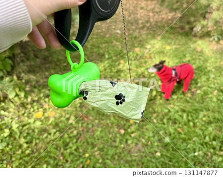 Bags for dog excrement on a tape measure Bags for dog excrement on a tape measure 131147877