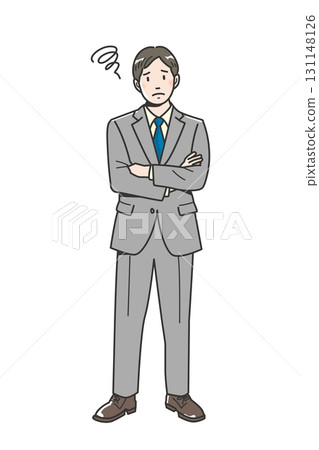 The whole body of a worried young businessman with his arms crossed 131148126