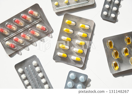 Many medicine blister packs with pills and capsules. Healthcare pharmaceuticals and medical supply. 131148267