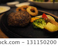 Juicy hamburger steak served on a hot plate 131150200