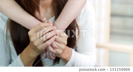 Close-up of mother and daughter holding hands, symbolizing love and support Close-up of mother and daughter holding hands, symbolizing love and support 131150909