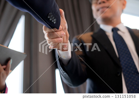 Successful close up hand asian businessman handshake with partnership during corporate. Successful close up hand asian businessman handshake with partnership during corporate. 131151058