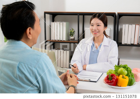 Asian nutritionist consulting patient in clinic, meal plan discussion, healthcare advice. Asian nutritionist consulting patient in clinic, meal plan discussion, healthcare advice. 131151078