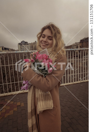 Blonde with a bouquet of pink tulips Blonde with a bouquet of pink tulips 131151706