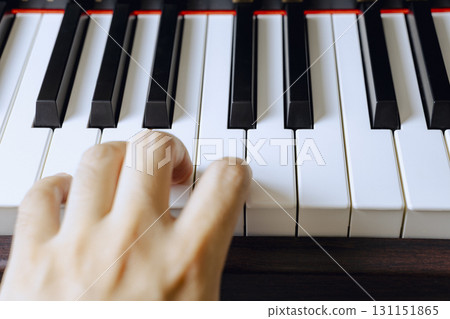 A man's hands practicing diligently to improve his piano skills. Close-up. Concept photo. A man's hands practicing diligently to improve his piano skills. Close-up. Concept photo. 131151865