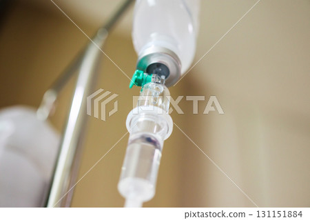 Close up medical intravenous IV drip in hospital background 131151884