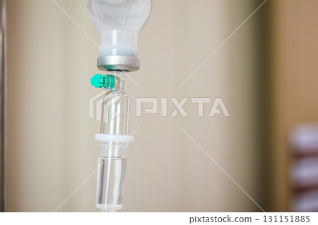 Close up medical intravenous IV drip in hospital background 131151885