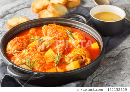 Chicken Bouillabaisse made with chicken, potatoes, takes its inspiration from the famous fish stew of the South of France closeup in the saucepan. Horizontal 131152839