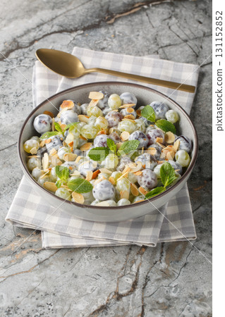 Close-up of grape mix salad with almonds dressed with creamy cheese sauce in a plate. Vertical Close-up of grape mix salad with almonds dressed with creamy cheese sauce in a plate. Vertical 131152852