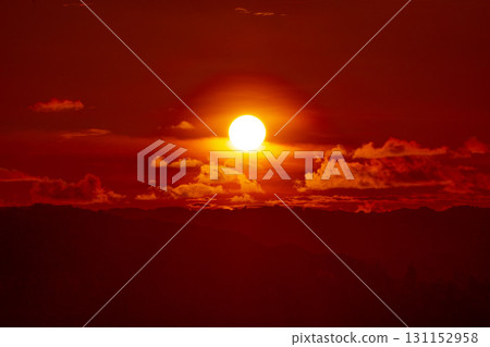 The morning sun emerging from the clouds 131152958