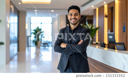 Reception staff greets visitors with a warm smile in the modern lobby of a stylish office building during daytime hours Reception staff greets visitors with a warm smile in the modern lobby of a stylish office building during daytime hours 131153352