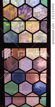 Purple and green honeycombe stained glass in medieval church. Mobile photography, real phone snapshot 131153454