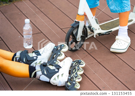 Preparation for roller skating and scootering in park 131153455
