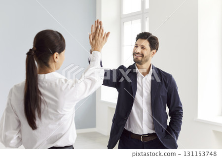 Realtor and client, man giving high five woman after successful meeting, deal, contract 131153748